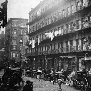 NEW YORK: TENEMENTS, 1912. A row of tenements on Elizabeth Street in the Lower East Side of Manhattan, New York. Photograph, by Lewis Wickes Hine, March 1912
