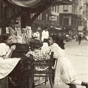 NEWSPAPER VENDORS, 1910. Three young girls working at a newspaper stand on Canal