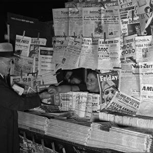 NEWSSTAND, 1941. Foreign language newspapers at an American newsstand. Photograph, 1941