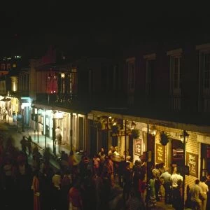 Nighttime view of Bourbon Street in the French Quarter of New Orleans, Louisiana, from the corner of St. Peter Street. Photographed c1974
