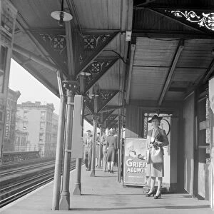 NYC: ELEVATED TRAIN, 1942. A woman waiting at the Third Avenue elevated railway