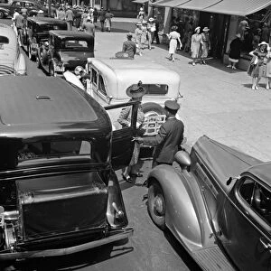 NYC: FIFTH AVENUE, 1939. A woman exiting a private limousine on 5th Avenue near