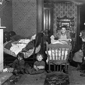 NYC: TENEMENT LIFE, c1910. A New York City tenement family. Photograph by Lewis Hine