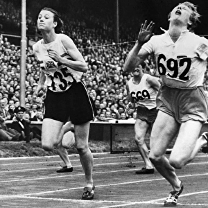 OLYMPIC GAMES, 1948. Fanny Blankers-Koen of the Netherlands (right) and Maureen Gardner (left) of England finishing the 80 meter hurdle event at Wembley Stadium, London, England, 4 August 1948