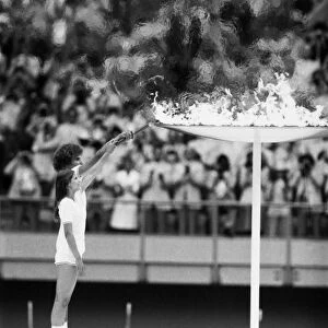 OLYMPIC GAMES, 1976. Torch bearers Sandra Henderson and Stephane Prefontaine lighting the Olympic flame at the opening ceremonies of the Summer Olympic Games in Montreal, Quebec, Canada, 17 July 1976