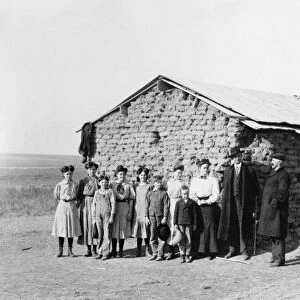 ONE-ROOM SCHOOLHOUSE, 1908. Children posing outside of a one-room sod schoolhouse at Oberlin