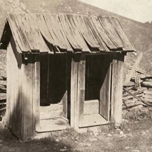 OUTDOOR TOILET, 1921. A toilet at the Buzzard School
