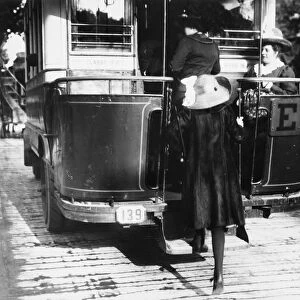 PARIS: OMNIBUS, c1920. A woman boards an omnibus in Paris, France. Photograph, c1920