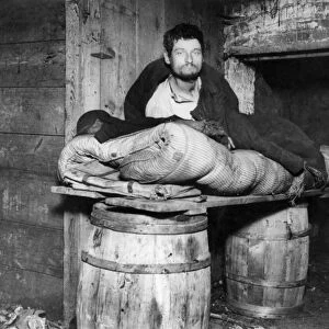 PEDDLERs BED, c1890. A peddler in his lodgings in the cellar of a Ludlow Street tenement