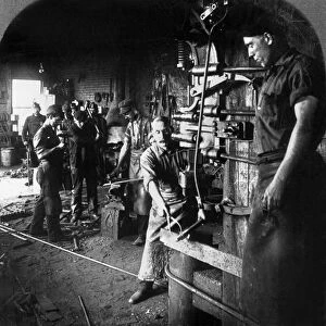 PENNSYLVANIA: BLACKSMITH. Men working with a pneumatic steam hammer and forges