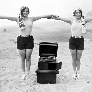 PHONOGRAPH, c1929. Joan Crawford and Dorothy Sebastian photographed c1929 with a portable phonograph in Santa Monica, California