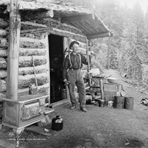 PIKEs PEAK: PROSPECTOR. A prospector stands outside his cabin on Pikes Peak, Colorado