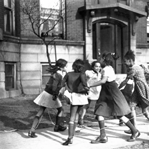 Playing ring around a rosie in the Black Belt neighborhood of Chicago: photograph, April 1941, by Edwin Rosskam