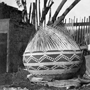 POMO BASKET WEAVER, c1900. A Pomo Native American woman of northwestern California
