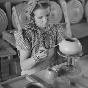 POTTERY MAKING, 1940. A woman working at a pottery wheel, possibly at the Indian