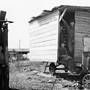 POVERTY: FAMILY, 1936. One-room wooden shelter for a family of eleven, built over