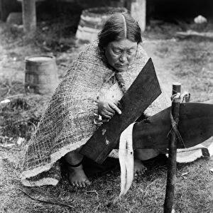 PREPARING CEDAR BARK, c1914. A Nak waxda xw woman preparing cedar bark, possibly