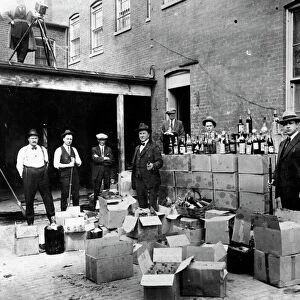 PROHIBITION, 1922. Revenue agents with confiscated bootleg liquor at Washington, D. C. Oct. 14, 1922