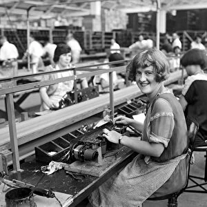 RADIO FACTORY, c1925. Worker Mary Ramsey beginning the assembly of a radio set