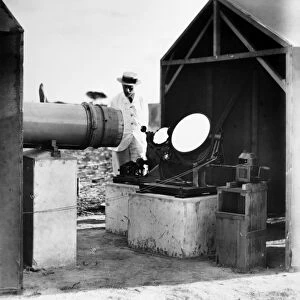 REFLECTING TELESCOPE, c1910. English reflecting telescope at an unidentified tropical location
