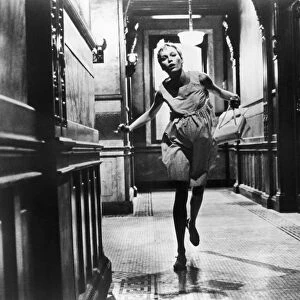 ROSEMARYs BABY, 1968. Mia Farrow, as Rosemary, running down a hallway at the Dakota on Central Park West, New York, in Rosemarys Baby directed by Roman Polanski, 1968