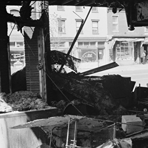 Ruins of a store in Washington, D. C. destroyed during the riots following the assassination of Martin Luther King, Jr. Photographed by Warren Leffler, 16 April 1968