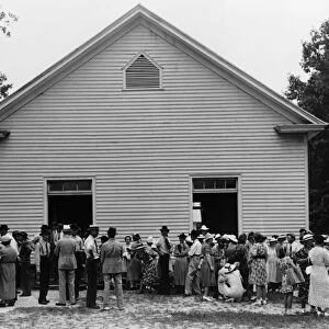 RURAL CHURCH, 1939. The gathering of a congregation after church services at Wheeley s
