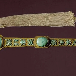A ruyi scepter and tassel with Buddhist symbols, presented to Emperor Ch ien Lung by a court official in 1783. Gold with turquoise inlay. Ching Dynasty
