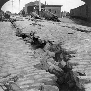 SAN FRANCISCO EARTHQUAKE. A cracked cobblestone street by the waterfront, following the earthquake of 18 April 1906. Stereograph, 1906