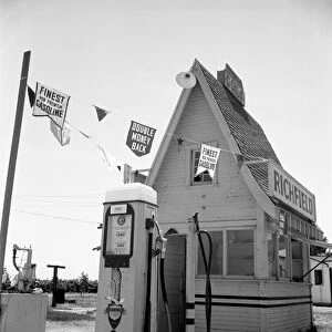 SERVICE STATION, 1939. A roadside service station between Tulare and Fresno on U. S. 99, California. Photograph by Dorothea Lange, May 1939