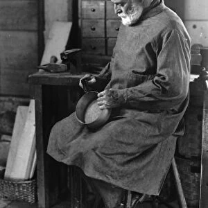 SHAKER ARTISAN, 1935. Ricardo Belden making wooden oval boxes in a workshop at