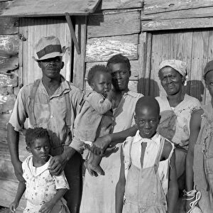 SHARECROPPER, 1936. Lewis Hunter and his family outside their home at Ladys Island