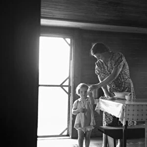 SHARECROPPER, 1939. The wife and child of a tobacco sharecropper inside their farm