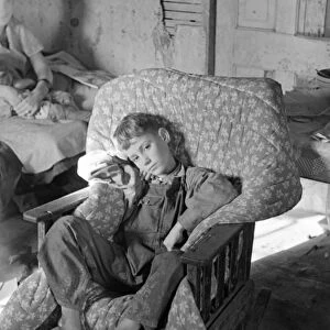 SICK CHILD, 1937. The son of John Scott, a migrant worker, recovering from a severe
