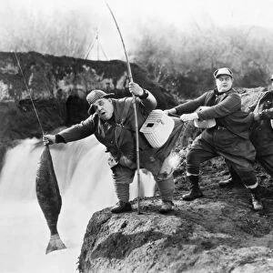 SILENT FILM STILL: SPORTS. Three fishermen in a scene from a silent film, early 20th century