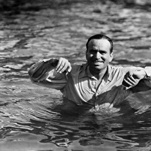 SILENT STILL: BATHING. Douglas Fairbanks swimming in a silent film