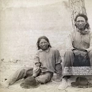 SIOUX BOYS, 1891. Three Lakota Sioux teenage boys in western clothing, sitting near a tree