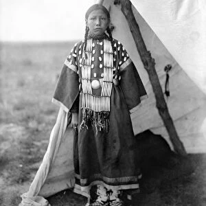 SIOUX GIRL, c1905. Rosa Lame Dog, a Sioux Native American girl, standing at the entrance to a tipi on the Great Plains. Photographed by Edward S. Curtis, c1905