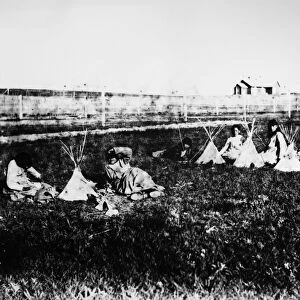 SIOUX GIRLS, c1892. A group of Sioux Native American girls playing with toy tipis