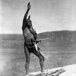 SIOUX INVOCATION, c1907. A Sioux Native American man raising his hand toward the sky to invoke the spirits. Photographed by Edward S. Curtis, c1907