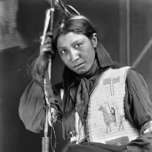 SIOUX NATIVE AMERICAN, c1900. Charles American Horse, a young Oglala Sioux, holding a peace pipe