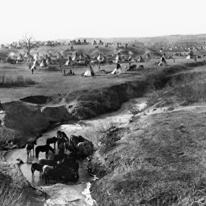 SIOUX NATIVE AMERICANS, 1891. Encampment of Brule and Oglala Sioux Native Americans on White Clay Creek, near Pine Ridge, South Dakota. Photograph, 1891, by John C. H. Grabill