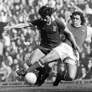 SOCCER TACKLE, 1976. Richie Powling of Arsenal FC (right) tackles a player of Ipswich Town FC during a soccer match in England, 1976