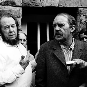 SOLZHENITSYN AND B├ûLL, 1974. Russian writer Alexander Solzehnitsyn (left) and German writer Heinrich B├Âll photographed outside B├Âlls residence in Langenbroich, West Germany, February 1974, following Solzhenitsyns exile from the Soviet Union
