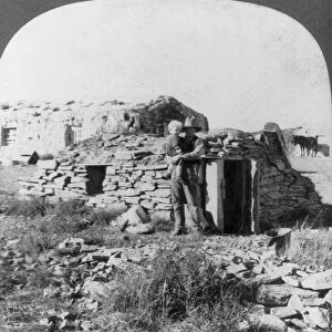 SQUATTER SHELTER, 1905. A squatters dug out in the North Dakota Bad Lands. Stereograph