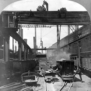 STEEL MILL, c1905. Large cranes loading finished steel products into railroad cars