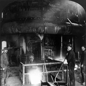 STEEL WORKERS, c1907. Steel workers at the lower level of a blast furnace at a