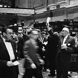 STOCK EXCHANGE, 1963. Stock brokers trading on the floor of the New York Stock Exchange