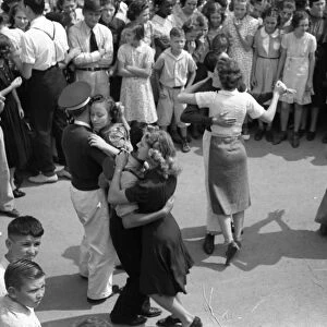 STREET DANCE, 1938. Young couples slow dance in the street at the National Rice Festival