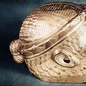 SUMERIAN GOLD HELMET. Gold wig helmet of Meskalam dug from the royal tombs at Ur, c2500 B. C